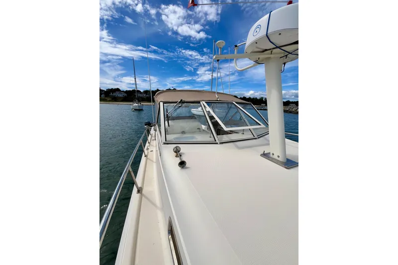 Slide: The Image of 2005 Mainship Pilot 30-II boat on calm water under a blue sky. - 31