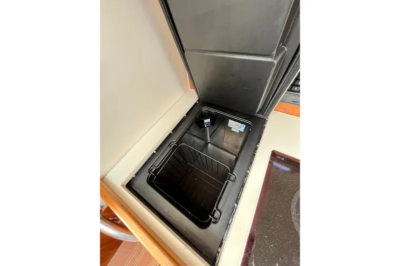 Slide: The Image of Open storage compartment in 2005 Mainship Pilot 30-II boat interior. - 38