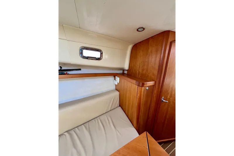 Slide: The Image of Interior of 2005 Mainship Pilot 30-II boat with wood paneling and seating. - 43