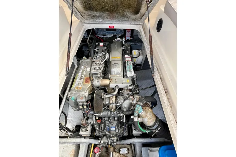 Slide: The Image of Engine compartment of a 2005 Mainship Pilot 30-II boat, featuring a Yanmar engine. - 49
