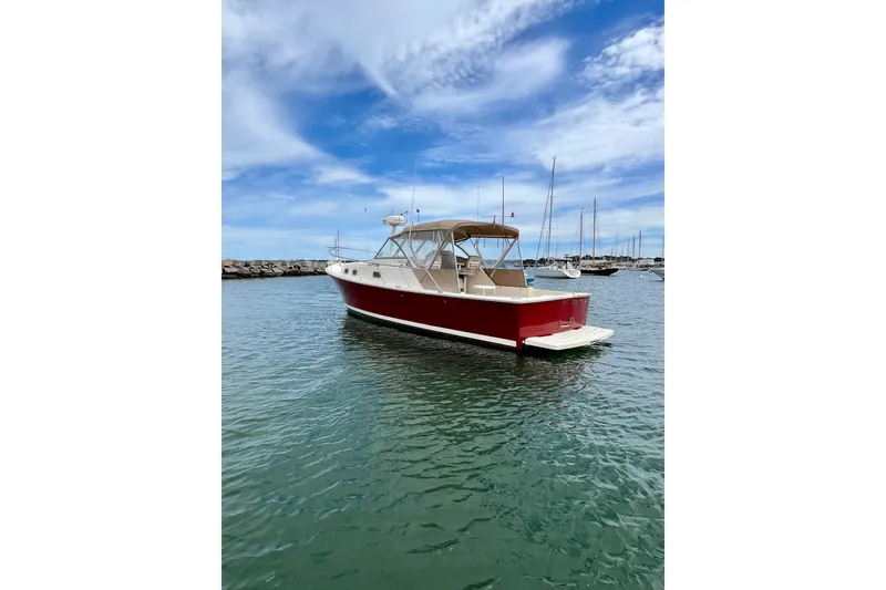 Slide: The Image of 2005 Mainship Pilot 30-II boat docked in a marina under a blue sky. - 8
