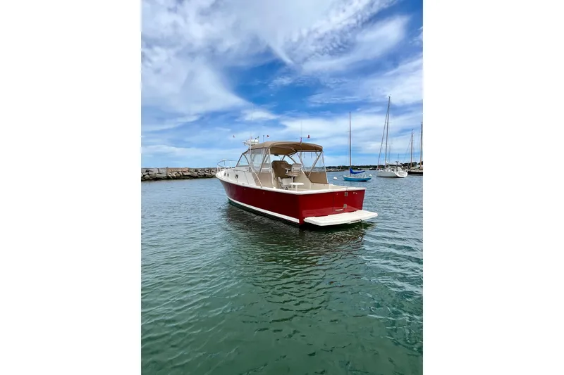 Slide: The Image of 2005 Mainship Pilot 30-II boat in harbor with clear sky and calm water. - 9