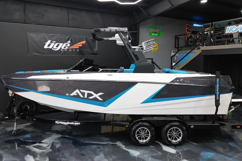 Slide: The Image of 2026 ATX Surf Boats 22 Type-S in showroom, sleek design with blue accents. - 3