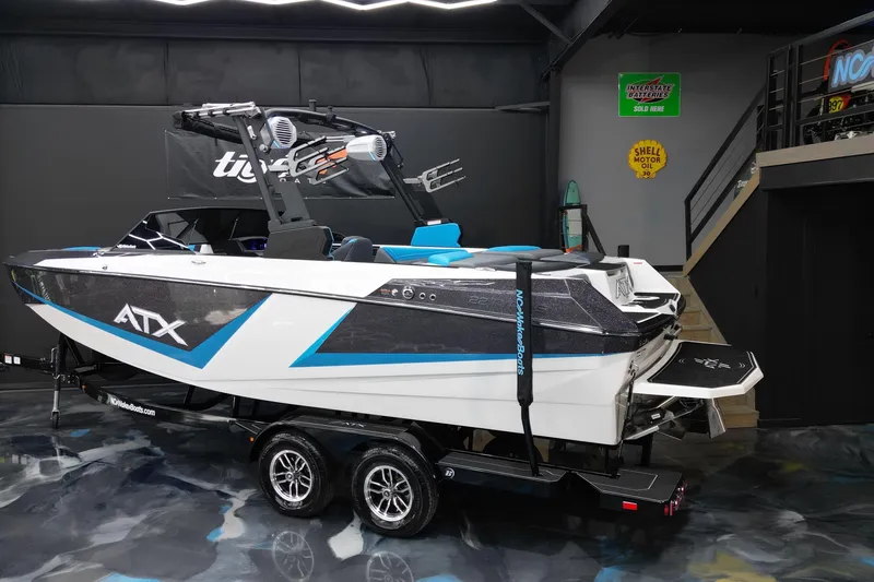 Slide: The Image of 2026 ATX Surf Boats 22 Type-S in showroom, sleek design with blue accents. - 5