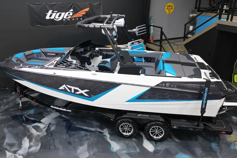 Slide: The Image of 2026 ATX Surf Boats 22 Type-S in showroom, featuring sleek design and vibrant blue accents. - 8