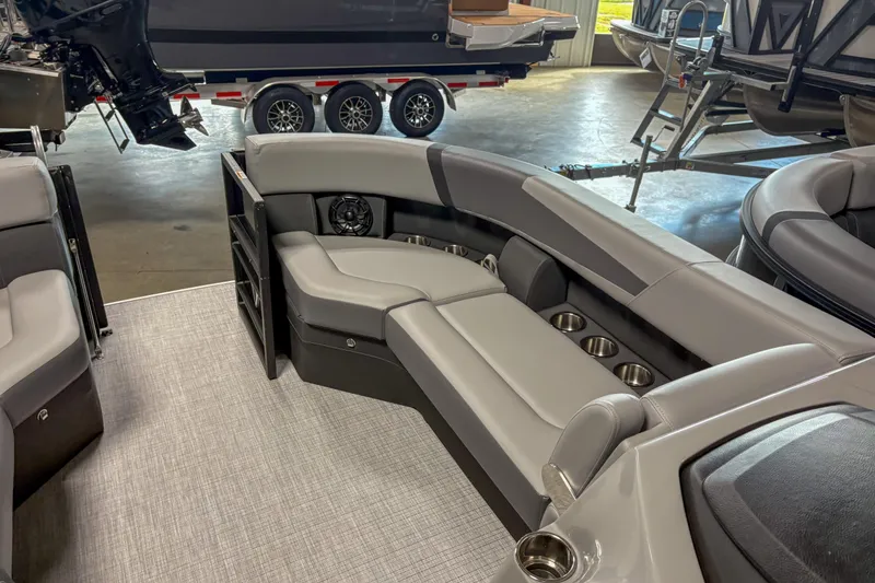Slide: The Image of 2025 Trifecta 24 RF CS pontoon boat interior with gray seating and cup holders. - 4