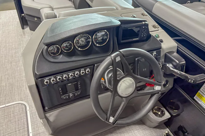 Slide: The Image of 2025 Trifecta 24 RF CS boat dashboard with steering wheel and control panel. - 6