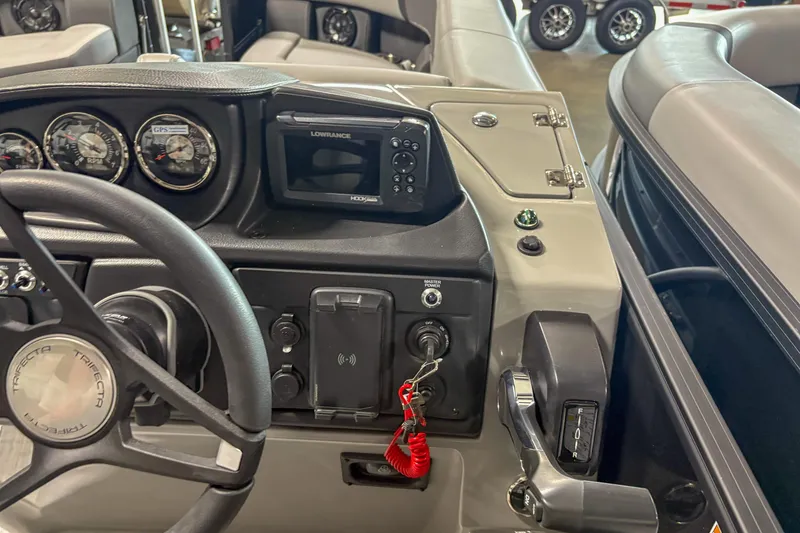 Slide: The Image of 2025 Trifecta 24 RF CS boat dashboard with steering wheel, gauges, and control panel. - 7