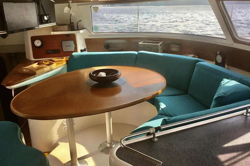 Slide: The Image of Interior of 2000 Fountaine Pajot Belize 43 catamaran with cozy seating and wooden table. - 10
