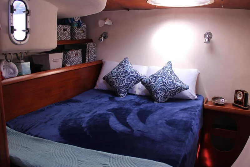 Slide: The Image of Cozy cabin interior of 2000 Fountaine Pajot Belize 43 with plush bedding and decorative pillows. - 11