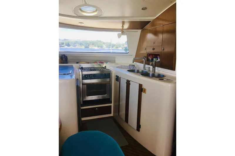 Slide: The Image of Interior of 2000 Fountaine Pajot Belize 43 yacht kitchen with stove and sink. - 12