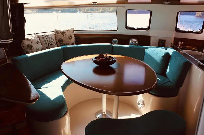 Slide: The Image of Fountaine Pajot Belize 43 catamaran deck with cushions, moored on a serene lake. - 15