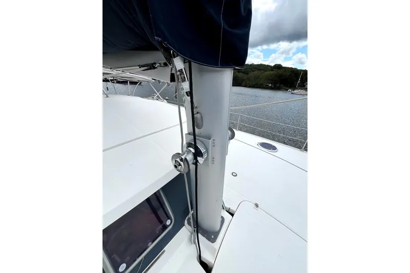 Slide: The Image of Fountaine Pajot Belize 43 catamaran on a serene lake, 2000 model, with lush greenery. - 20