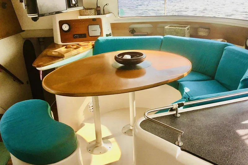 Slide: The Image of Interior of 2000 Fountaine Pajot Belize 43 catamaran with cozy seating and wooden table. - 5