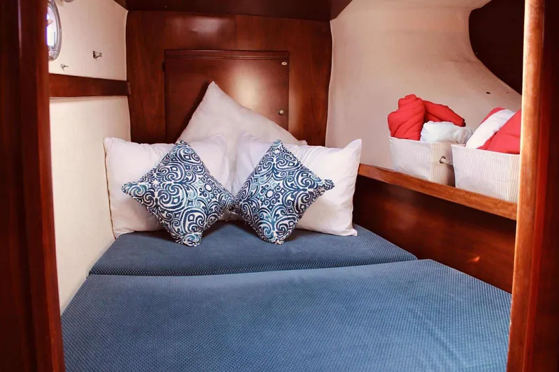 Slide: The Image of Cozy cabin interior of 2000 Fountaine Pajot Belize 43 with decorative pillows and storage baskets. - 7