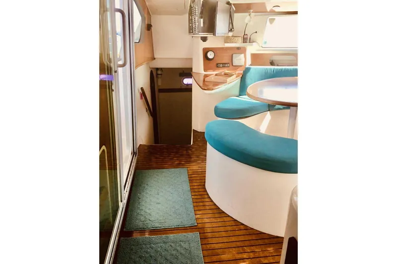 Slide: The Image of Interior of 2000 Fountaine Pajot Belize 43 catamaran with teal seating and wooden flooring. - 9