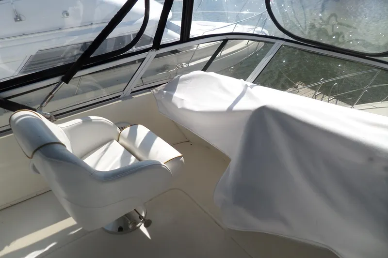 Slide: The Image of Captain's chair and covered console on 2000 Sea Ray 380 Aft Cabin yacht. - 10
