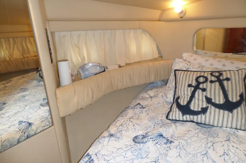Slide: The Image of Cozy cabin interior of 2000 Sea Ray 380 Aft, featuring nautical-themed bedding. - 102