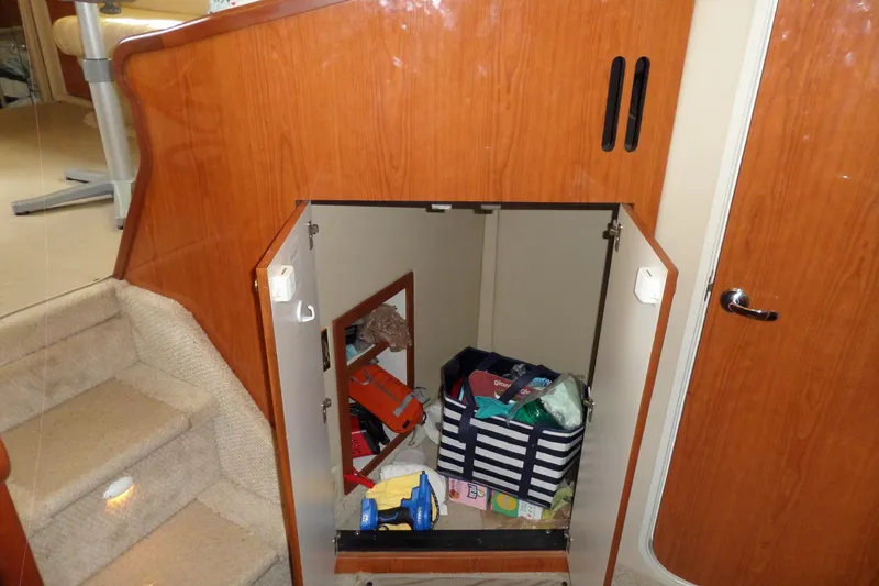 Slide: The Image of Storage compartment on 2000 Sea Ray 380 Aft Cabin yacht, containing various items. - 106
