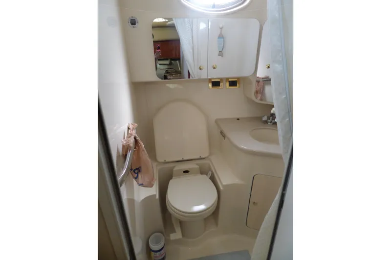 Slide: The Image of Compact bathroom in 2000 Sea Ray 380 Aft Cabin yacht, featuring toilet and sink. - 107