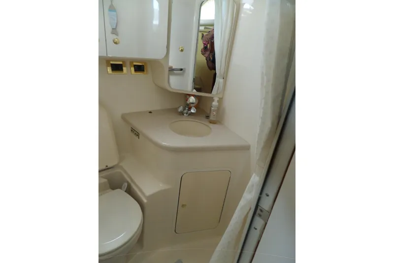 Slide: The Image of Bathroom interior of 2000 Sea Ray 380 Aft Cabin yacht, featuring sink and mirror. - 108