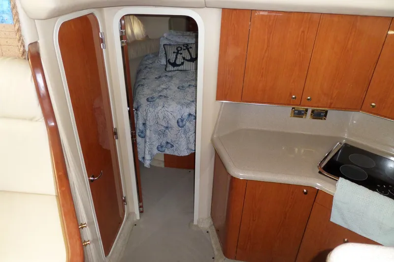Slide: The Image of Interior of 2000 Sea Ray 380 Aft Cabin with kitchenette and cozy bedroom. - 111