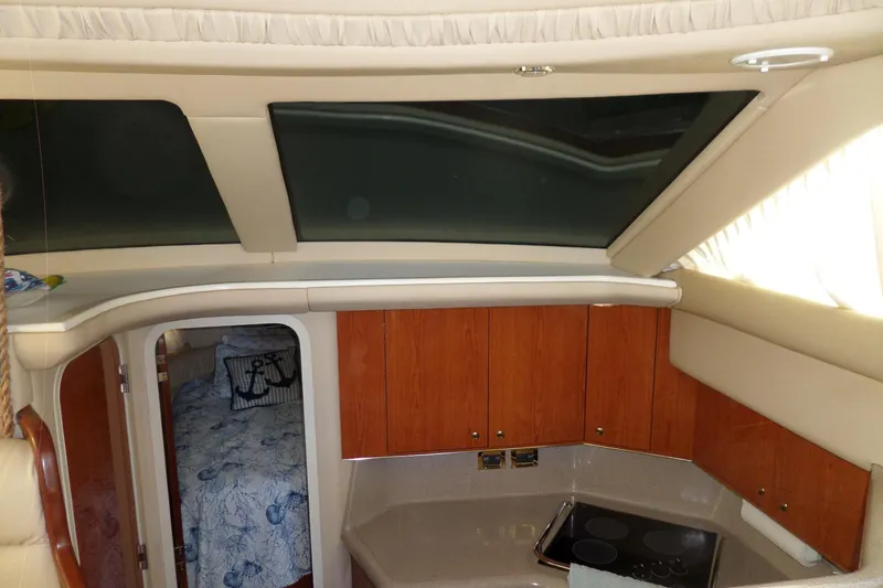 Slide: The Image of Interior of 2000 Sea Ray 380 Aft Cabin with wood cabinets and skylight. - 112