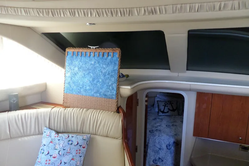 Slide: The Image of Interior of 2000 Sea Ray 380 Aft Cabin with nautical-themed decor and seating. - 113
