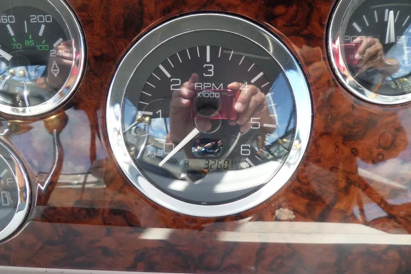 Slide: The Image of Dashboard gauges of a 2000 Sea Ray 380 Aft Cabin boat. - 114