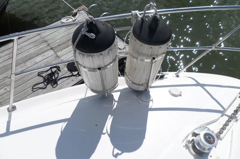 Slide: The Image of 2000 Sea Ray 380 Aft Cabin boat deck with fenders and dock view. - 117