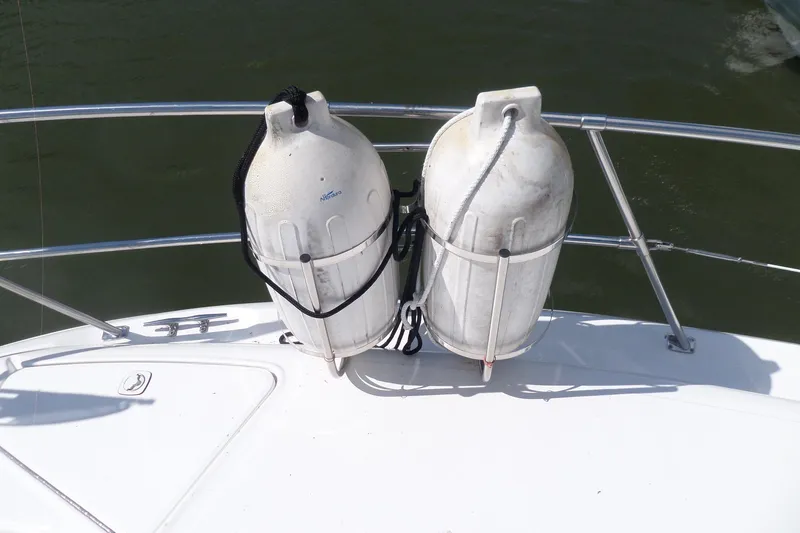 Slide: The Image of Two large white fenders on a 2000 Sea Ray 380 Aft Cabin boat deck. - 118