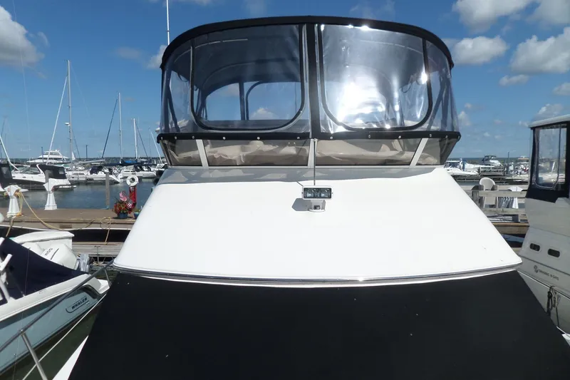 Slide: The Image of 2000 Sea Ray 380 Aft Cabin yacht docked at marina under blue sky. - 119