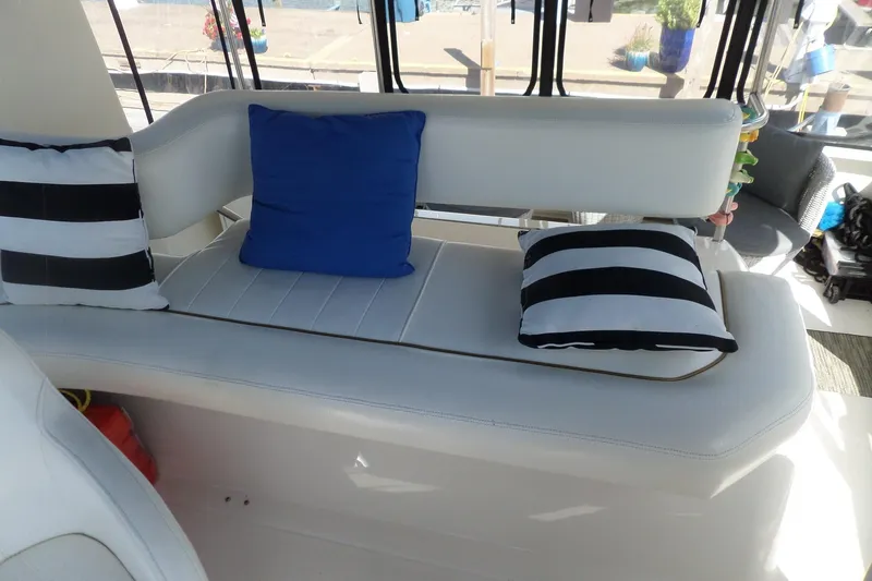Slide: The Image of Interior seating of 2000 Sea Ray 380 Aft Cabin with striped and blue cushions. - 14