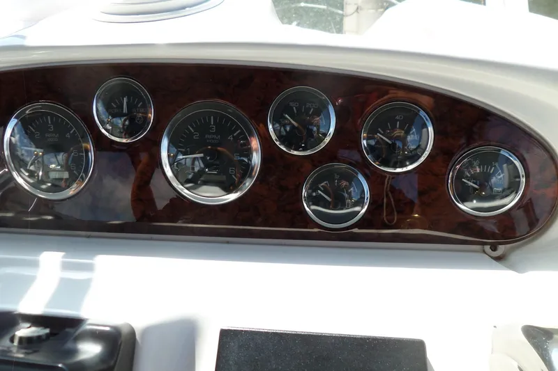 Slide: The Image of Dashboard of a 2000 Sea Ray 380 Aft Cabin boat with multiple gauges. - 22