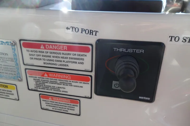 Slide: The Image of Control panel of 2000 Sea Ray 380 Aft Cabin with thruster joystick and safety warnings. - 32