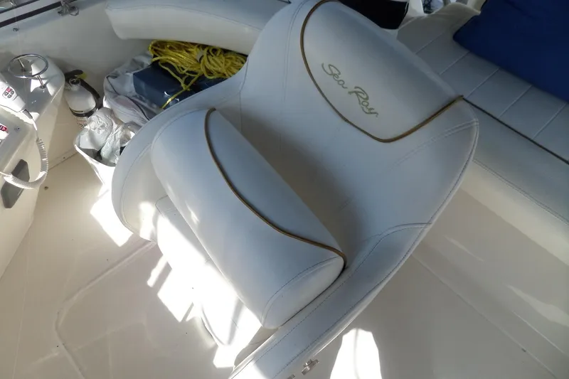 Slide: The Image of White Sea Ray 380 Aft Cabin boat seat, 2000 model, with nautical accessories nearby. - 33