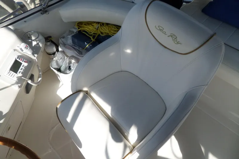 Slide: The Image of White captain's chair on 2000 Sea Ray 380 Aft Cabin boat, with control panel nearby. - 34