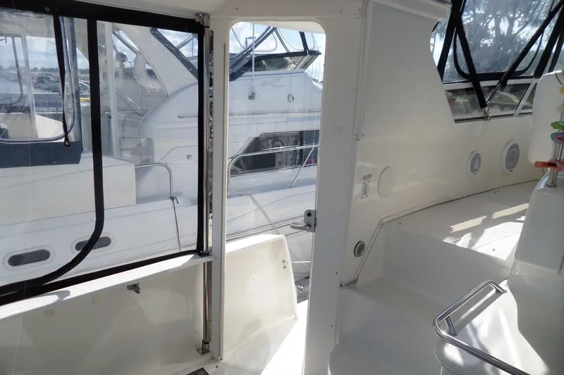 Slide: The Image of 2000 Sea Ray 380 Aft Cabin interior with white seating and windows. - 35