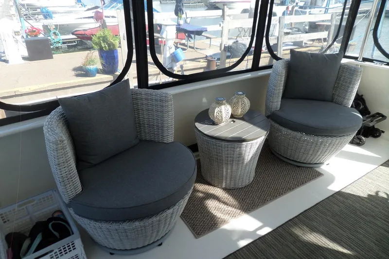 Slide: The Image of Cozy seating area on 2000 Sea Ray 380 Aft Cabin yacht with wicker chairs and table. - 37