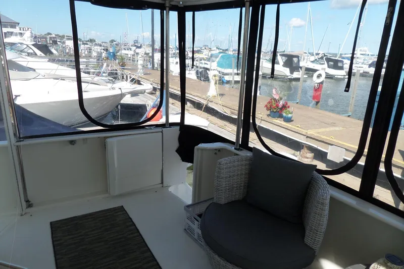 Slide: The Image of 2000 Sea Ray 380 Aft Cabin interior with marina view, featuring comfortable seating. - 39