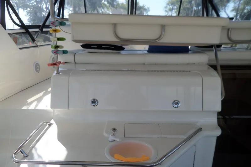 Slide: The Image of 2000 Sea Ray 380 Aft Cabin interior with fishing rod holders and compact sink. - 42