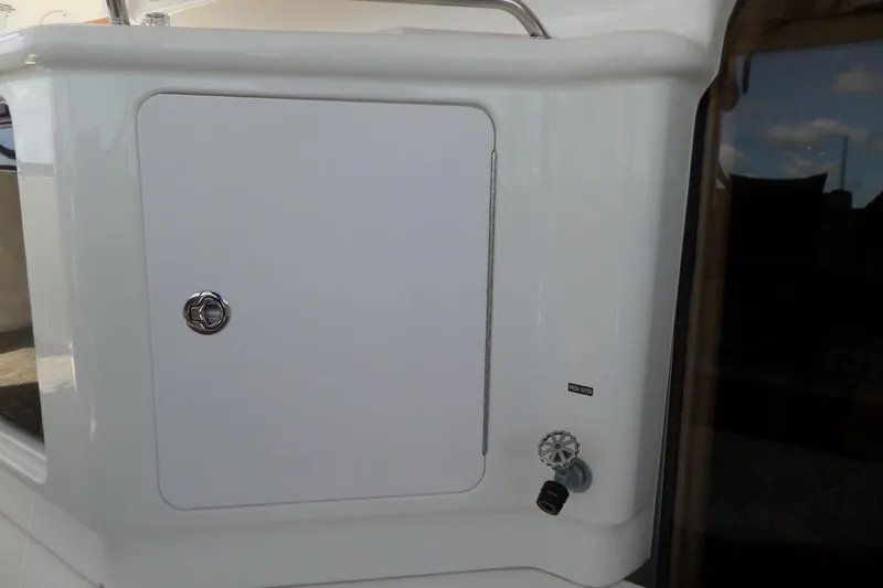 Slide: The Image of 2000 Sea Ray 380 Aft Cabin yacht detail with storage compartment and water valve. - 45