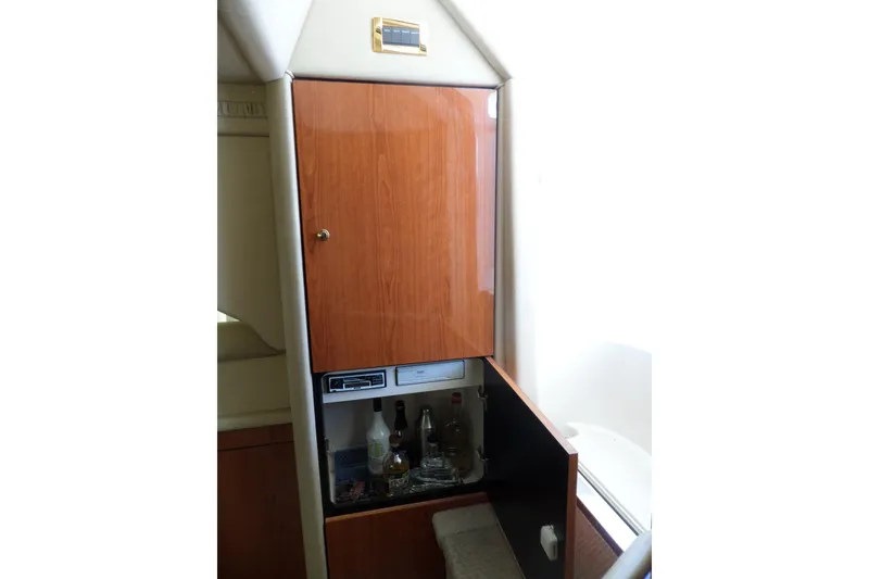 Slide: The Image of Interior of 2000 Sea Ray 380 Aft Cabin with wooden cabinet and bar setup. - 48