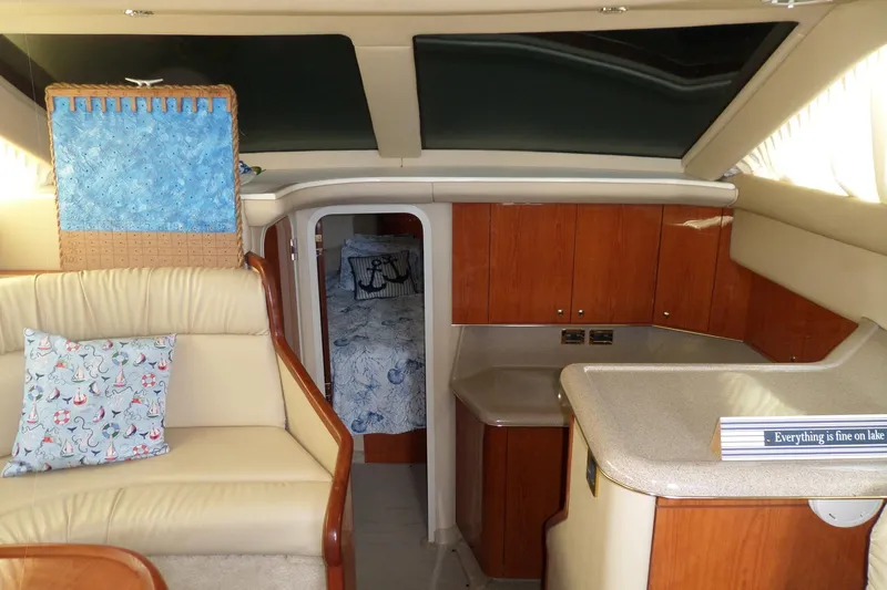 Slide: The Image of Interior of 2000 Sea Ray 380 Aft Cabin yacht with cozy seating and nautical decor. - 52