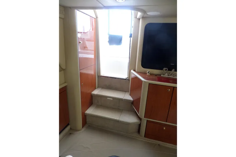 Slide: The Image of Interior of 2000 Sea Ray 380 Aft Cabin with steps and wooden cabinetry. - 59