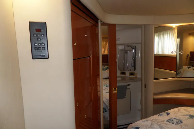 Slide: The Image of Interior of 2000 Sea Ray 380 Aft Cabin with wood paneling and cozy bedroom. - 60