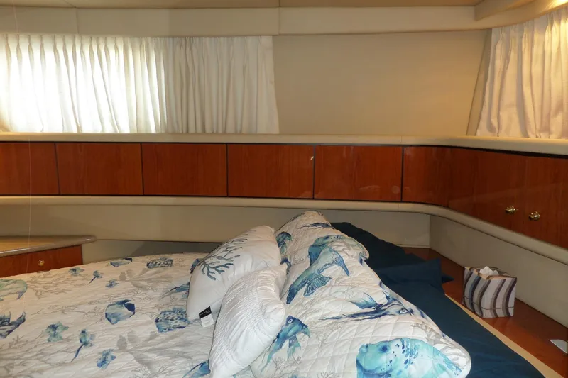 Slide: The Image of Cozy cabin interior of 2000 Sea Ray 380 Aft Cabin with nautical-themed bedding. - 62