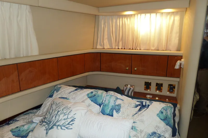 Slide: The Image of Cozy cabin interior of 2000 Sea Ray 380 Aft Cabin with nautical-themed bedding. - 63