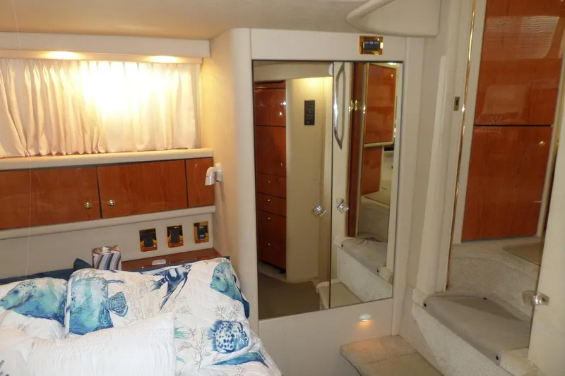 Slide: The Image of 2000 Sea Ray 380 Aft Cabin interior with cozy bedroom and wooden cabinetry. - 64