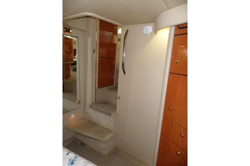 Slide: The Image of Interior of 2000 Sea Ray 380 Aft Cabin with stairs and wooden cabinetry. - 65